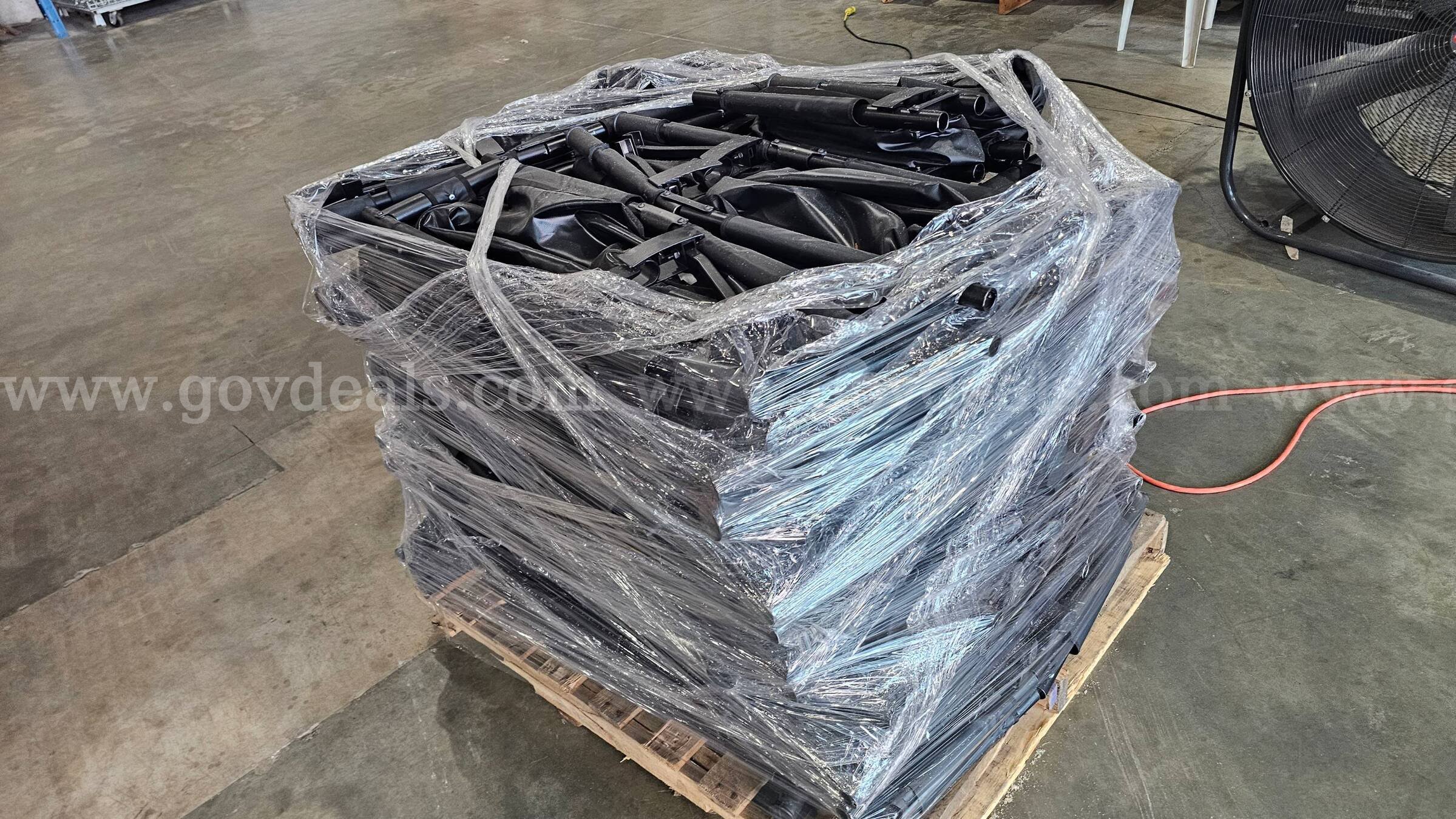 pallet of approximately 30 black folding Military style field stretchers.