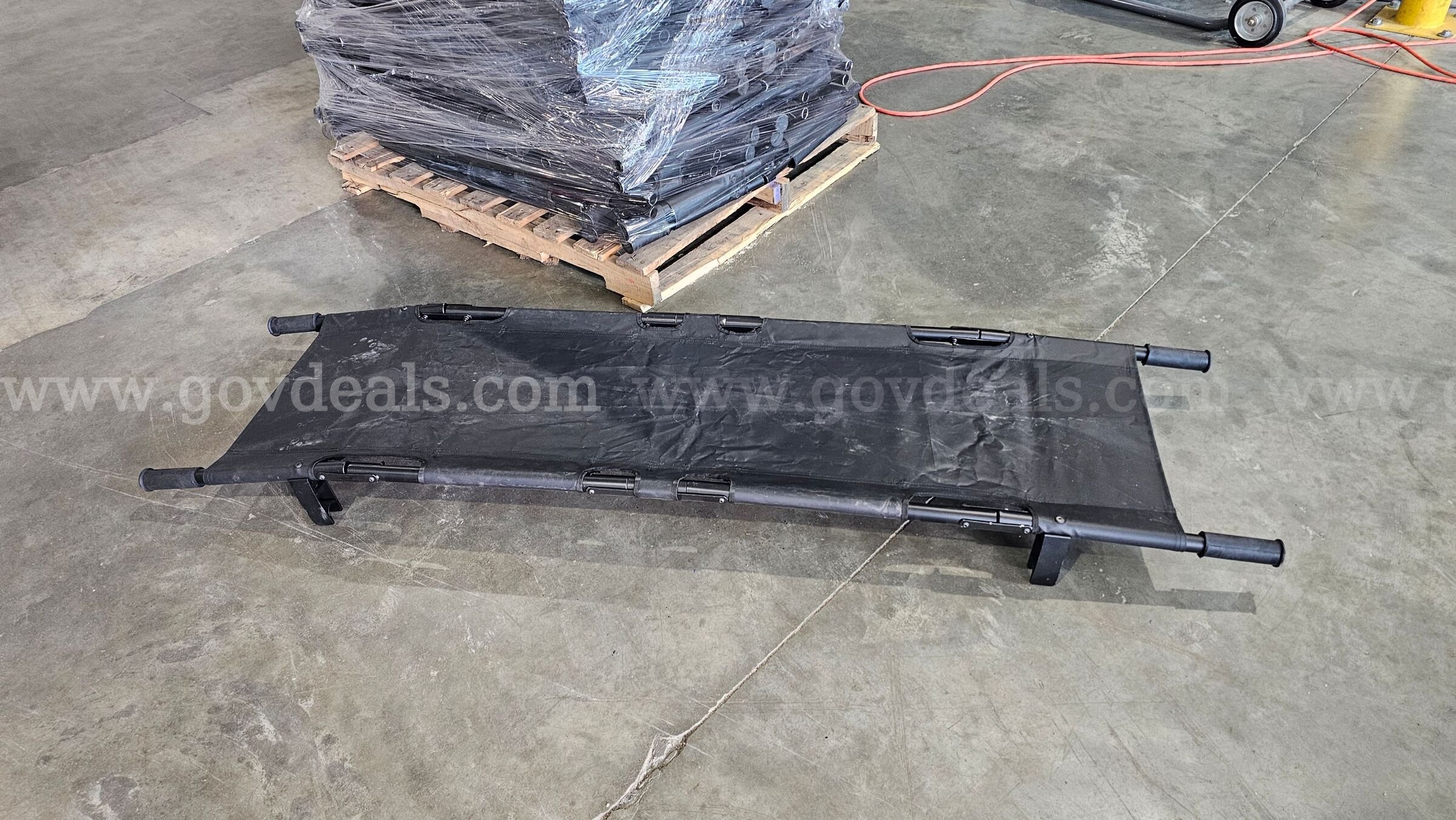 pallet of approximately 30 black folding Military style field stretchers.   Government Surplus Auction - Photo #2