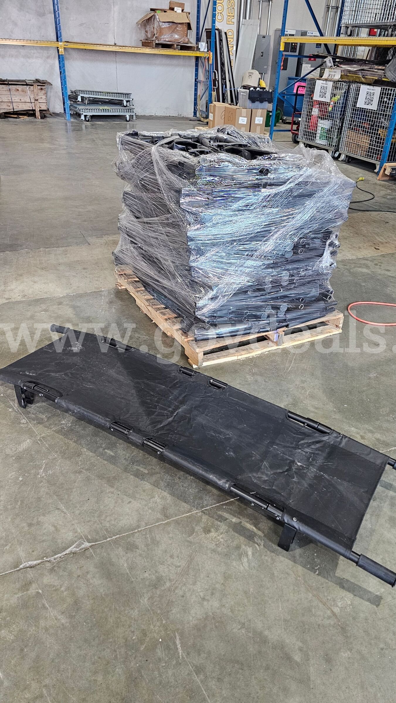 pallet of approximately 30 black folding Military style field stretchers.   Government Surplus Auction - Photo #4
