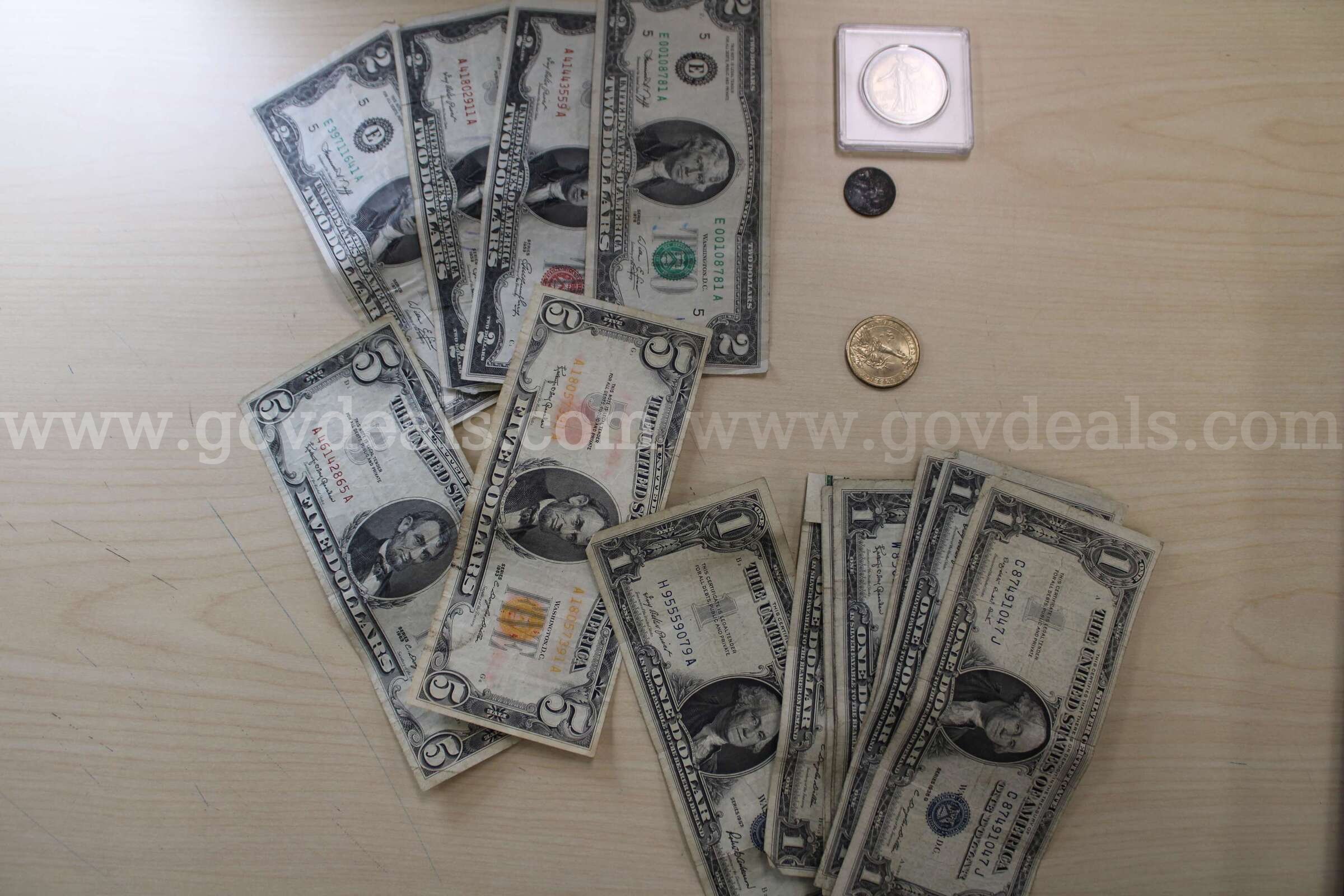 $2.00 BILL (4), $5.00 BILL (2), $1.00 (9), $1.00 COIN (1), 0.50 COIN (1),   Government Surplus Auction - Primary Photo