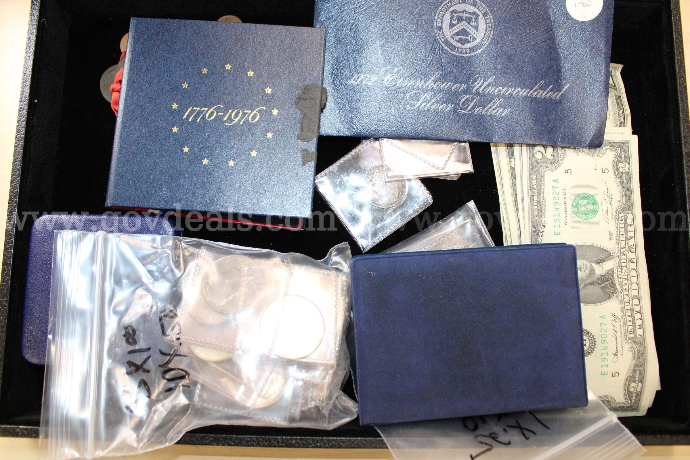 $1 BILL (2); $2 BILL (8); TOKENS ON CORD; QUARTER (1); DIME (2); NICKEL (4); PEN   Government Surplus Auction - Primary Photo