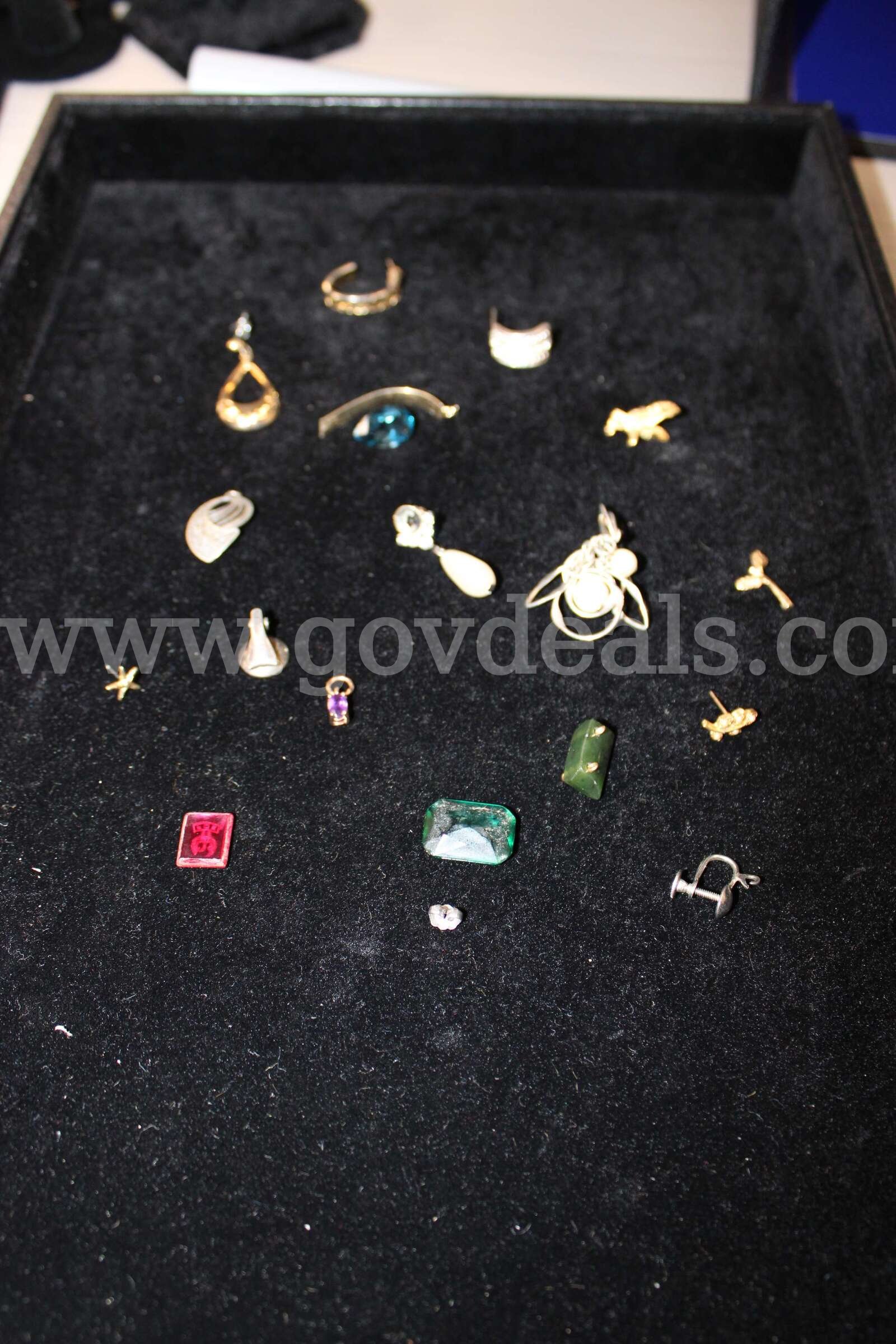 1 SILVER PEARL EARRING, 2 LOOSE STONES, 1 RED AND GOLD STONE, 7 EARRINGS, PURPLE   Government Surplus Auction - Primary Photo
