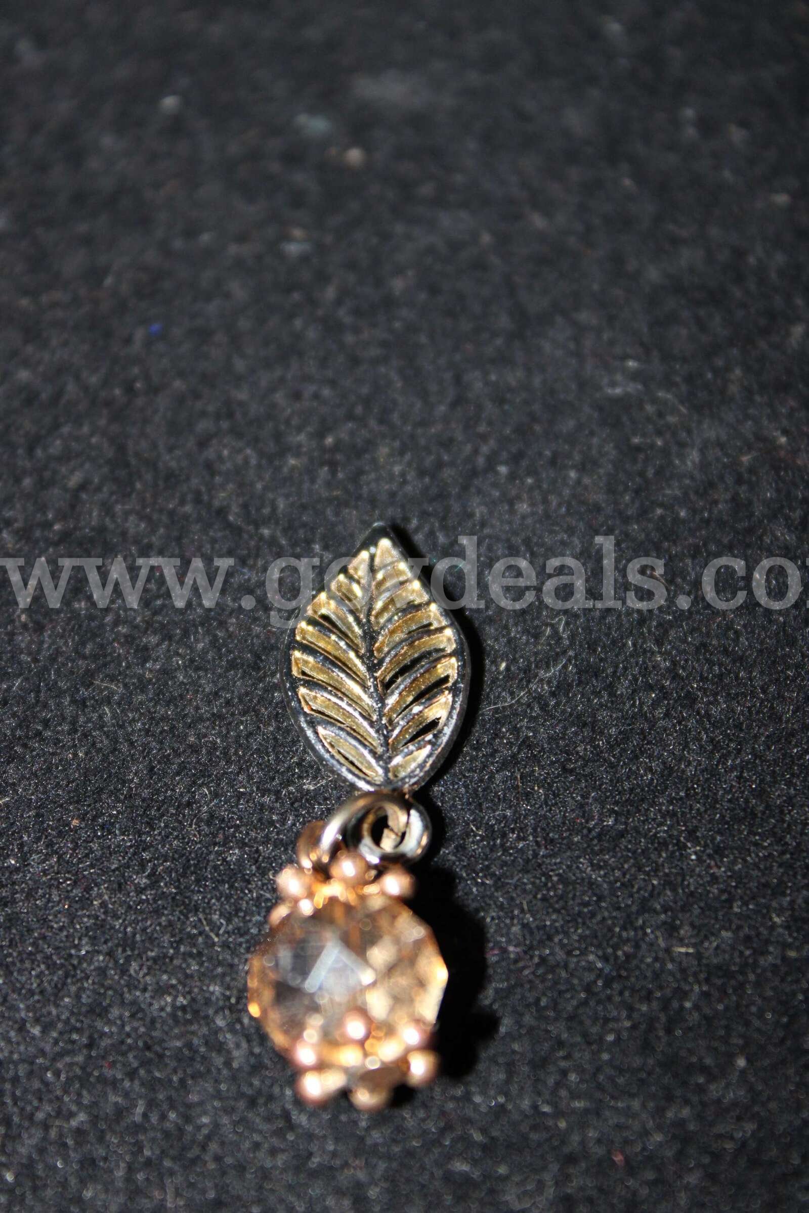 1 EARRING CYRSTAL LIKE YELLOW IN COLOR   Government Surplus Auction - Primary Photo