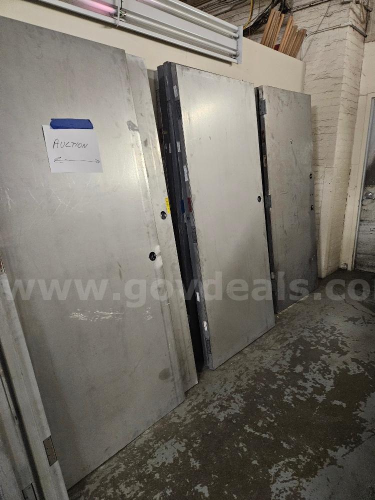 20 Metal Doors and 8 Stack of Metal Door Bucks. Sold As Is.   Government Surplus Auction - Primary Photo