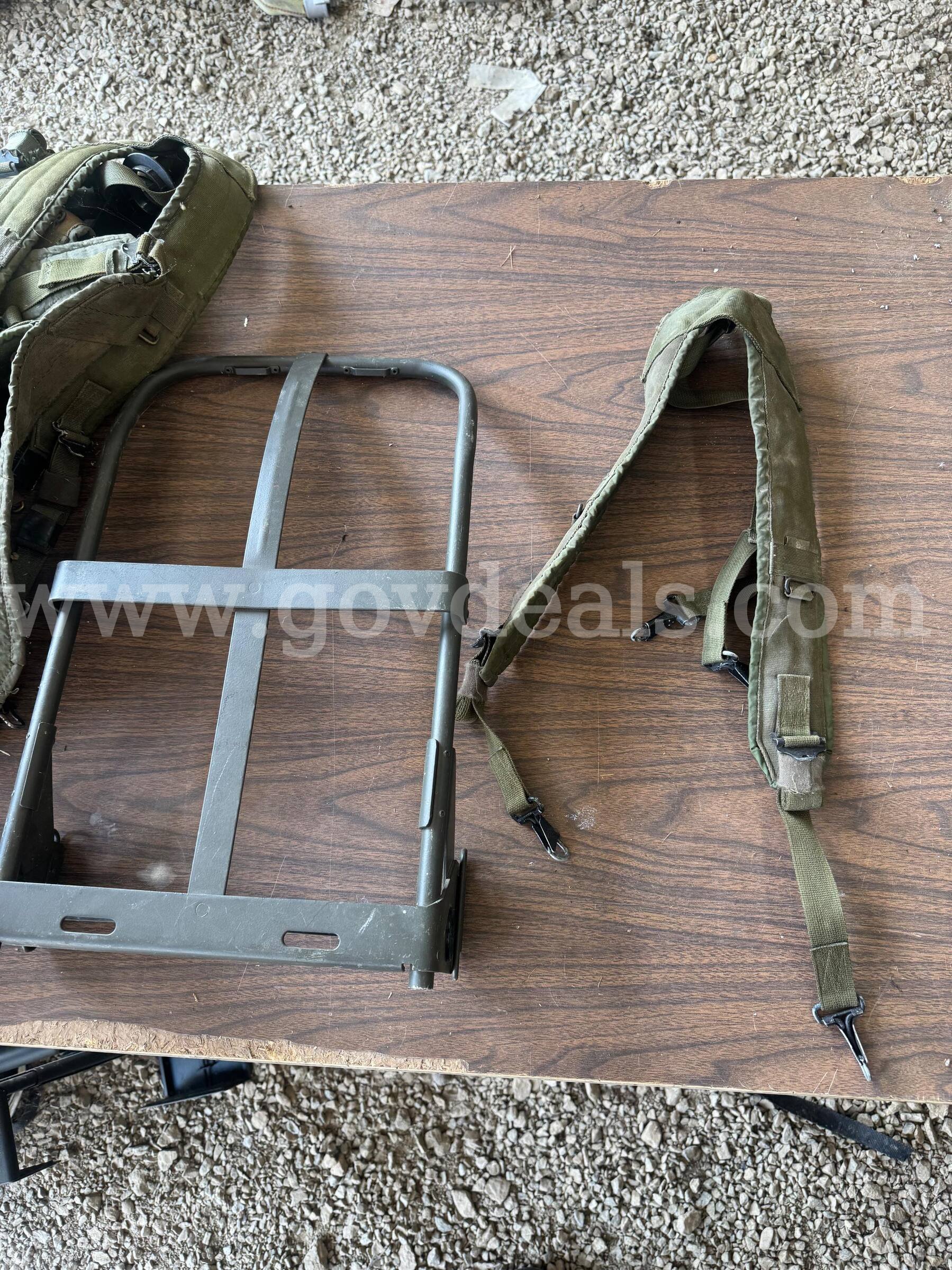 Metal external pack frames with padded shoulder harnesses and straps.   Government Surplus Auction - Primary Photo