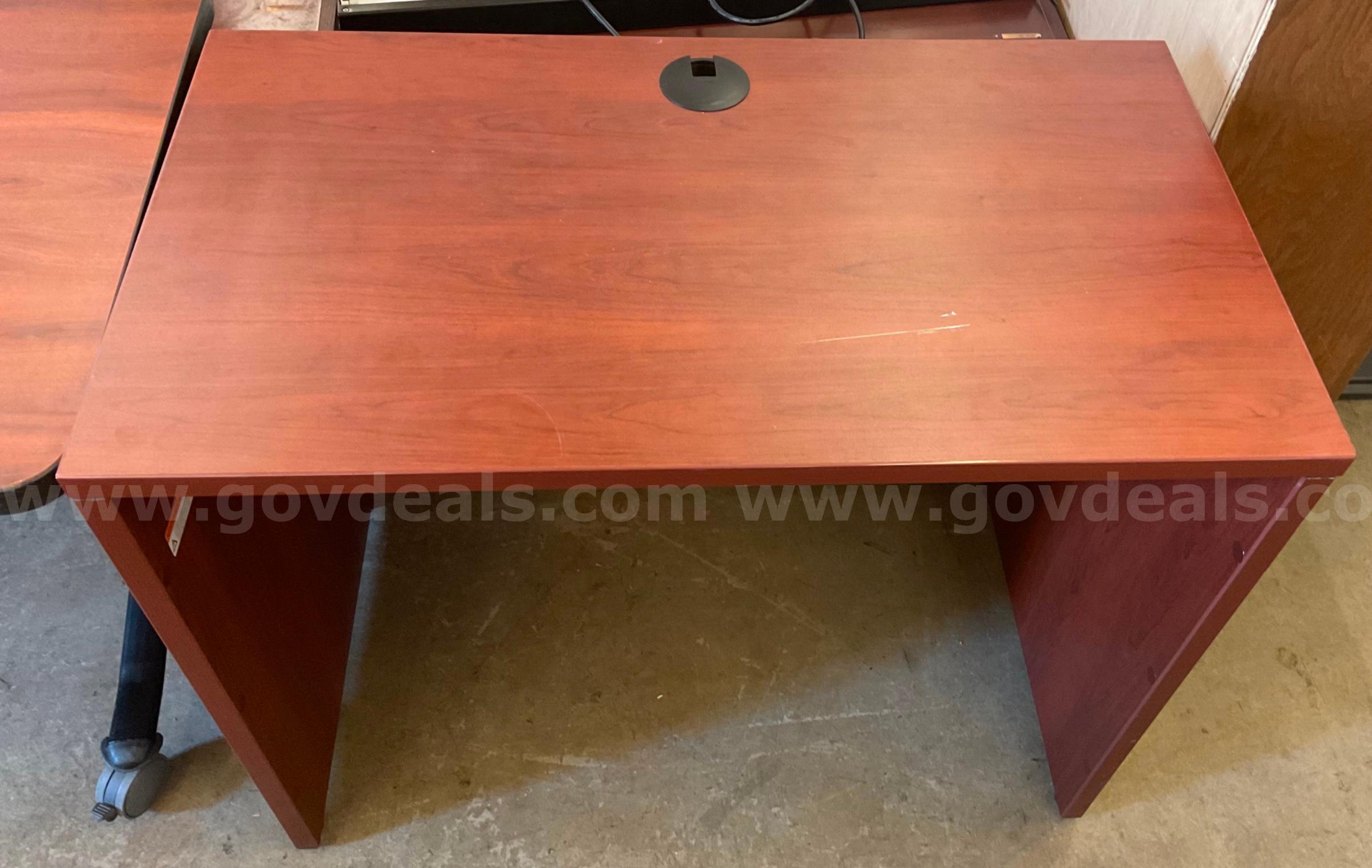 Small brown computer desk   Government Surplus Auction - Primary Photo
