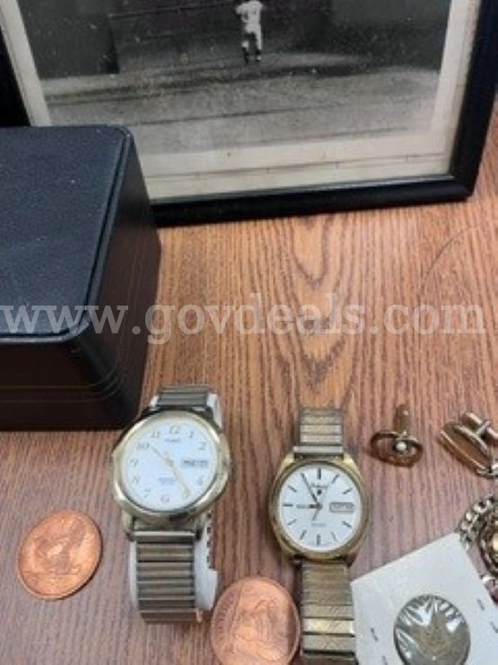 1 Small lot containing: 2 watches, cuff links, 1 necklace, 1 bracelet, and a framed photo of "The Catch"   Government Surplus Auction - Primary Photo